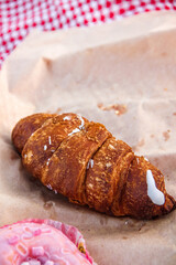 close-up delicious croissant and donut lie on a tablecloth. picnic concept, free space