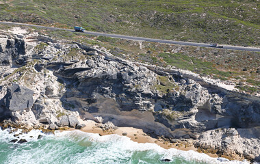 Cape Town, Western Cape / South Africa - 11/22/2019: Aerial photo of Baden Powell Drive and cliffs overlooking the sea