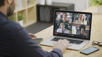 Back view of businessman joining a remote call with multi ethnic colleagues from home. Business Remote meeting or remote conference. Multi ethnic team video call. - Powered by Adobe