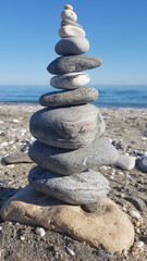 Zen concept. Object made of stone on the beach. Stone pyramid for meditation. Harmony and Meditation. Zen stones.