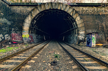 Fototapeta na wymiar Old stony tunnel with double-track railway
