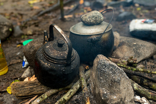 Jungle trekking in the Gunung Leuser National Park. Campsite with campfire and teatime in the rainforest on the orangutan observation tour in the jungle of Ketambe