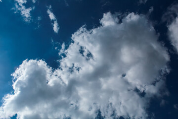 Fototapeta premium A large white cloud against the sky of azure color.