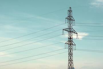 Old film effect. High-voltage line. Electric tower with wires against the sky.