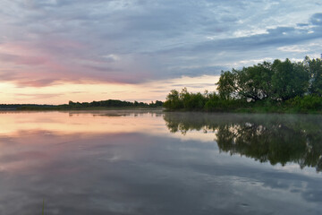Fototapeta na wymiar colorful dawn on a small river