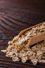 raw oatmeal on a wooden rustic background