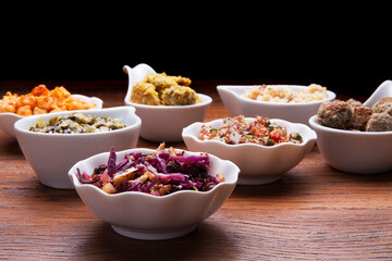 Nutrition concept - Healthy meals in white bowls over wooden background. Healthy food, Diet, Detox, Clean Eating or Vegetarian concept. 