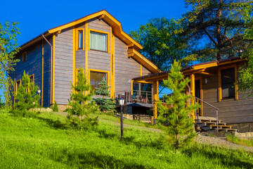 Cottage with a bath in a Pine forest. Cottages are rented out. Landscape design. Family vacation in nature. Houses among the trees. Rest from the city bustle. Construction of country houses.