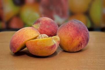 fresh peaches on a wooden background, Fruits of organic peaches whole and halves