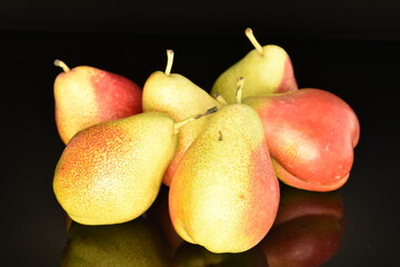 Organic juicy pears, close-up, on a black background.