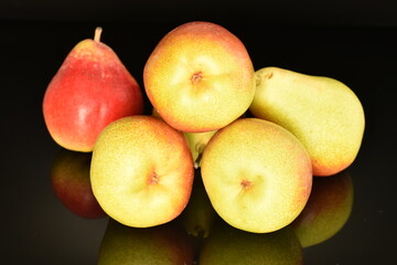 Organic juicy pears, close-up, on a black background.