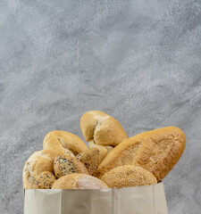 Bread variety in disposalable paper bag.