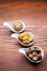 Nutrition concept - Healthy meals in White bowls , hamburguer and meat balls over wooden background. Healthy food, Diet, Detox, Clean Eating or Vegetarian concept. Top view, flat lay.
