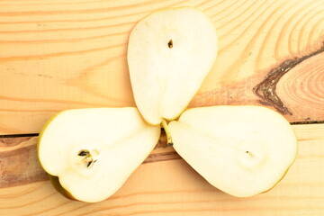 Organic juicy pears, close-up, on a wooden table.
