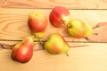 Naklejka na ściany i meble Organic juicy pears, close-up, on a wooden table.
