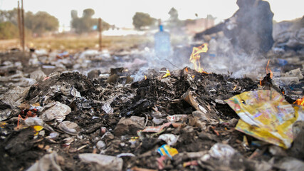 Burning trash and poor Indian old man.