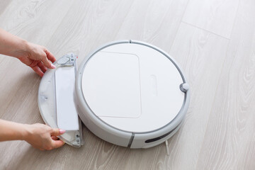 Robotic vacuum cleaner. Container with garbage from a smart robot vacuum cleaner. housework and...