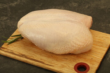 Raw whole chicken breast with skin