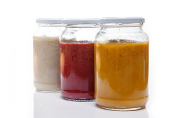 Nutrition concept - Healthy food, Diet, Detox, Clean Eating or Vegetarian concept. Glass jars of nutritious food against white background. Delicious soups in glass jars. 