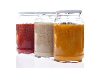 Nutrition concept - Healthy food, Diet, Detox, Clean Eating or Vegetarian concept. Glass jars of nutritious food against white background. Delicious soups in glass jars. 