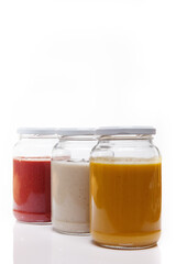 Nutrition concept - Healthy food, Diet, Detox, Clean Eating or Vegetarian concept. Glass jars of nutritious food against white background. Delicious soups in glass jars. 