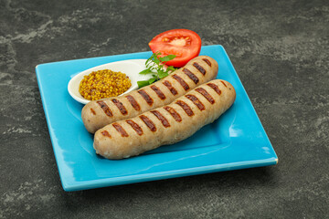 Grilled natural pork sausages with sauce