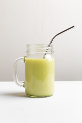 Matcha green tea latte in glass jar