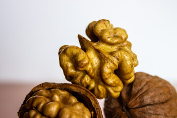 Walnut kernel inshell, peeled and halves, close up macro. A walnut is the nut of tree of the genus Juglans (Family Juglandaceae)