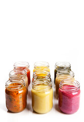 Nutrition concept - Healthy food, Diet, Detox, Clean Eating or Vegetarian concept. A set of nutritious food on small glass jars against white background. Set of delicious food in glass jars. Top view