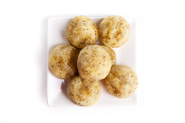 Healthy homemade cheese buns with chia on a white plate over white background.