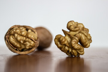 Walnut kernel inshell, peeled and halves, close up macro. A walnut is the nut of tree of the genus Juglans (Family Juglandaceae)