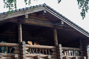 balcony of a wooden house made of a thick log
