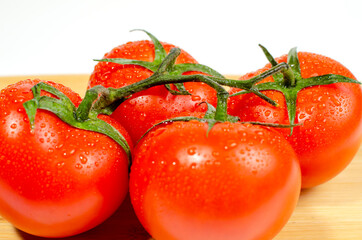 Close-up of red tomato on wooden background.