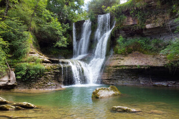 Fototapeta na wymiar Idyllic rain forest waterfall, stream flowing in the lush green forest. High quality image.