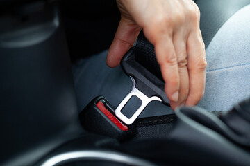 Fastening seatbelt on vehicle. Drive save.