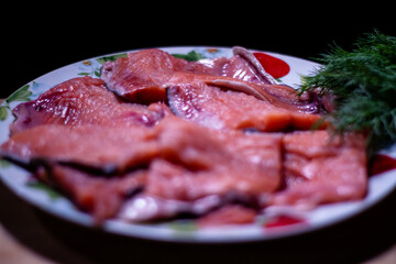 pieces of red fish fillet on a plate with greens.