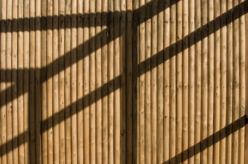 Wooden round logs background. Timber planks pavement above.