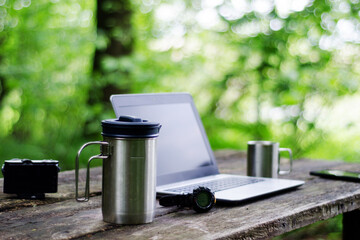 Computer Coffee Mug and Telephone on black wood table.