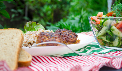 Cutlets with buckwheat porridge and salad. Healthy eating concept. Macro photo. Top view and side view. Erupny plan of the dish.