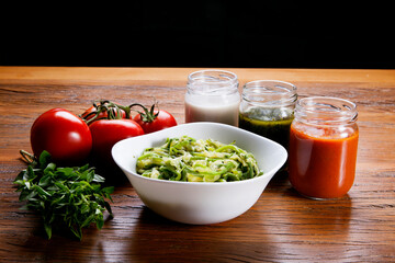 Nutrition concept - Healthy food, Diet, Detox, Clean Eating or Vegetarian concept. Healthy pasta with sauce, basil, fresh tomatoes over rustic wooden background