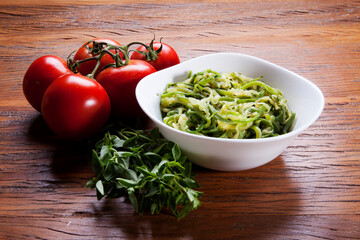 Nutrition concept - Healthy food, Diet, Detox, Clean Eating or Vegetarian concept. Healthy pasta with sauce, basil, fresh tomatoes over rustic wooden background