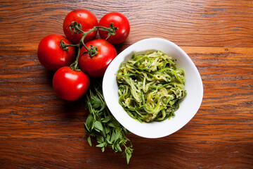 Nutrition concept - Healthy food, Diet, Detox, Clean Eating or Vegetarian concept. Healthy pasta with sauce, basil, fresh tomatoes over rustic wooden background