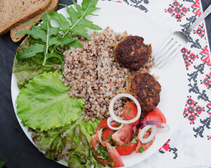 Cutlets with buckwheat porridge and salad. Healthy eating concept. Macro photo. Top view and side view. Erupny plan of the dish.