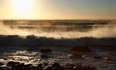 Cape Town, Western Cape / South Africa - 04/15/2011: Waves crash on a beach at sunset