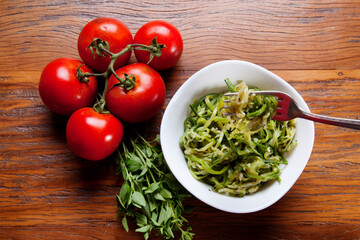 Nutrition concept - Healthy food, Diet, Detox, Clean Eating or Vegetarian concept. Healthy pasta with sauce, basil, fresh tomatoes over rustic wooden background