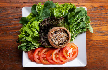 Nutrition concept - Healthy food, Diet, Detox, Clean Eating or Vegetarian concept. A delicious quiche with salads and tomatoes slices in white plate over wooden background.