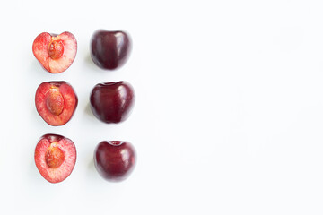 Ripe cherry cut in half, on a white background, macro shot. Copy space