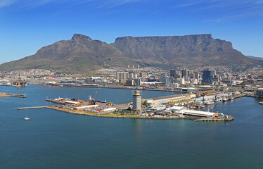 Obraz premium Cape Town, Western Cape / South Africa - 10/14/2013: Aerial photo of Port Control Tower in Table Bay Harbour with Table Mountain in the background