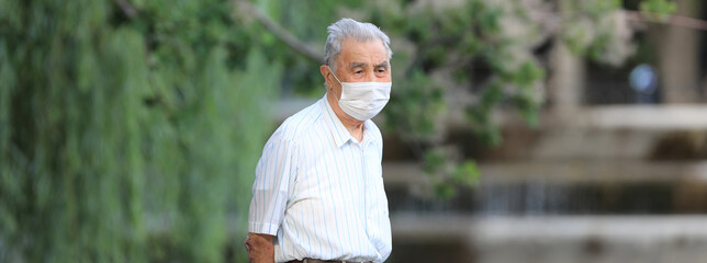 portrait of an old man in a medical mask
