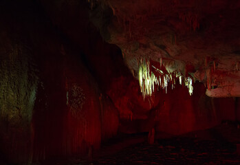 Stalactites and stalagmites at Prometheus Cave in colorful light, Georgia